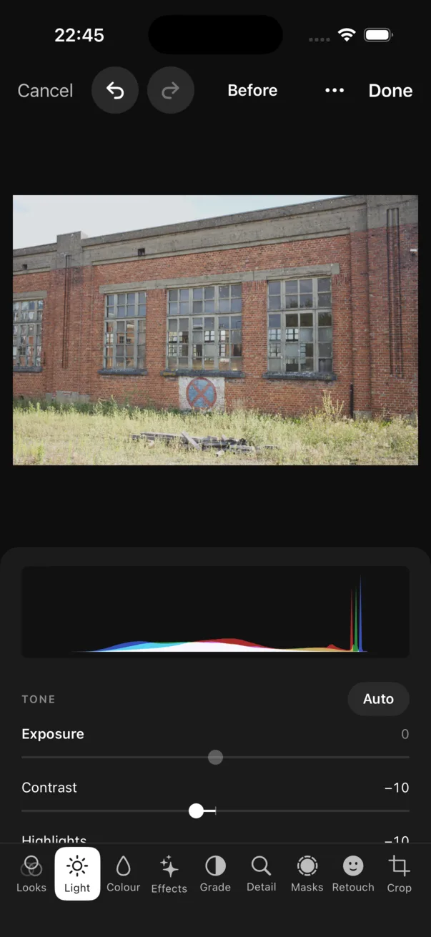 The iPhone editor on Light: the photograph at the top, the histogram, Tone with Auto, and the tab bar at the bottom