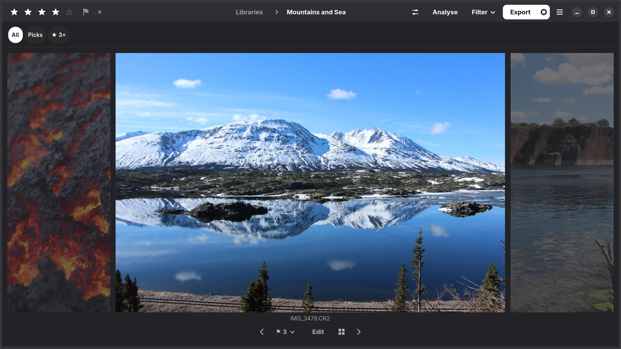 The loupe: a mountain lake large, the neighbouring photographs dimmed at either side, four stars, pick and reject at the top left, and the bar with the pick counter and Edit underneath